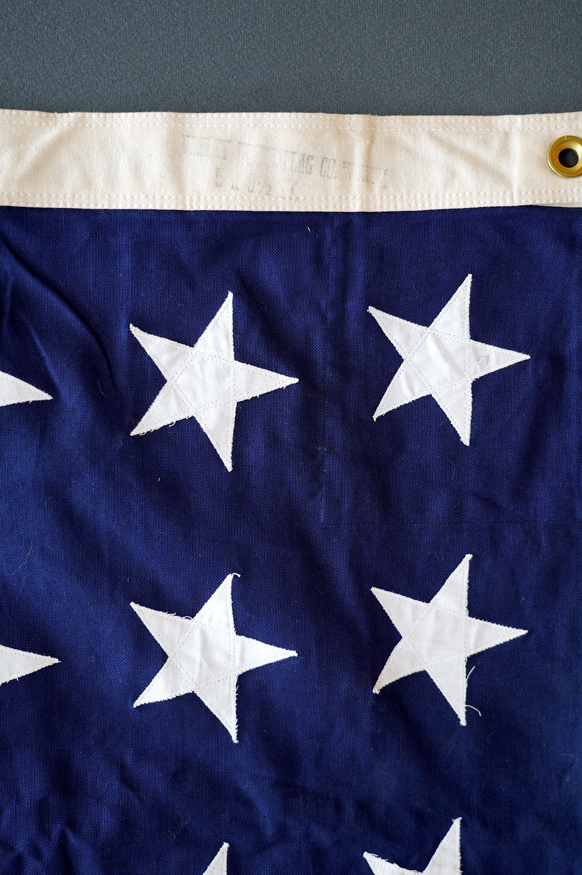 Four flags; two professionally made US Stars and Stripes, both on thick canvas with applied stars and joined stripes, one by the Valley Forge Flag Co., Pennsylvania, stamped “5 x 9.5 ft”, 146 x 288cm and 176 x 300cm, tog